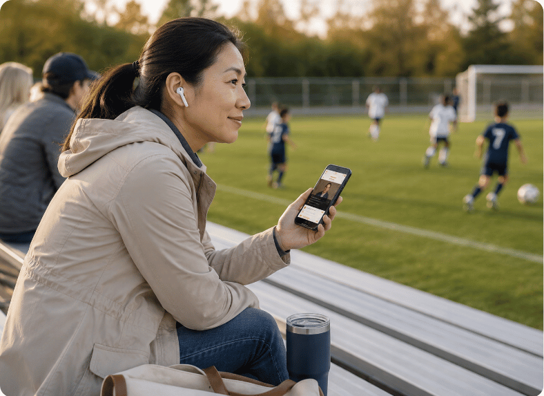 A parent watching a conference session during soccer practice